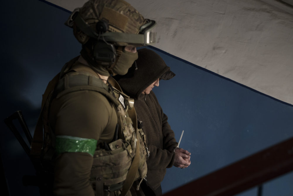 A Security Service of Ukraine (SBU) serviceman detains a man suspected to be a Russian collaborator in Kharkiv, Ukraine, Thursday, April 14, 2022. (Felipe Dana/AP)
