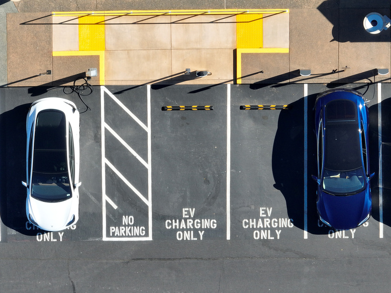 In an aerial view, Tesla cars recharge at a Tesla charger station in Corte Madera, Calif., on Feb. 15, 2023. The Biden administration wants to boost sales of electric cars, but it also wants to incentivize U.S.-based production. (Justin Sullivan/Getty Images)
